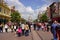 Walking visitors in theme park in front of a cute castle at cloudy but sunny day. Paris France, 29. May 2019