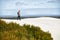 Walking through the wilderness. Shot of a young male hiker walking along the sand dunes.