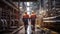 Walking workers in work clothes in a refinery with pipes and machinery