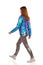 Walking Young Woman In Vibrant Down Jacket And Shiny Pants