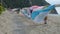 Walkway along wooden guard rails on beach with swaying beach towels hung over