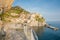 Walkway around rock coastal edge leading to traditional and brig