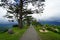 Walkway and benches in Japanese garden on mountaintop with panorama view