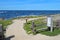 Walkway, fence and signs at Asilomar State beach in Pacific Grove, California