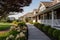 walkway leading to a shingle style house with gambrel roof