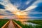 Walkway Path in the Lake. Boardwalk, Wooden Bridge for Nature Trail. Beautiful Sunset