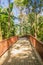 Walkway into the publuc temple in the forest that constructed with brick floor and steel fence