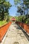 Walkway into the publuc temple in the forest that constructed with brick floor and steel fence