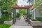 Walkway in residential area between two rows of townhouses with unit for sale