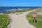 Walkway and sign for Asilomar State beach in Pacific Grove, Cali