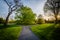 Walkway and trees at sunset, at Cylburn Arboretum, in Baltimore, Maryland.