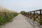 Walkway with wooden fence of a wide bike path