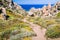 Walky path between bizarre granite rock formations in Capo Testa, Sardinia, Italy