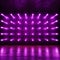 Wall adorned with bright purple LED lamps, creating an incandescent atmosphere