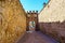 Wall attached to the aqueduct of Segovia with arched access doors, Spain.