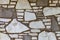 Wall background with irregular sized white and brown stones