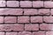 Wall of baked bricks colored in deep pink