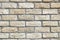 Wall from beige bricks front view closeup