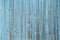 Wall of blue wooden slats. Exfoliated blue paint.