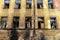 Wall with broken windows. abandoned apartment building after a fire