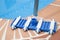 Wall Brush and Leaf Skimmer Maintenance Tools on Deck Beside Swimming Pool