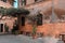 wall of a building with potted plants. Charming facade with shutters. Paved sidewalk