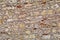The wall built of irregular stones background. Texture of old stonework. Space for text. The concept of reliability