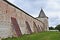 Wall with buttresses and tower of ancient monastery