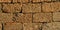 The wall of cinder blocks under the rays of the evening sun. Background image