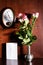 Wall clock, blank sheet of paper and pink roses