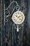 Wall Clock with Decorative Wrought Iron Butterfly Hanger on Blue