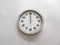 Wall clock isolated on a white wall, read at 12 o`clock.