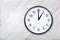 Wall clock on marble texture show one o`clock. Office clock show 1pm or 1am