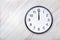 Wall clock on marble texture show twelve o`clock. Office clock show midday or midnight