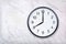 Wall clock show eight o`clock on white marble texture. Office clock show 8pm or 8am