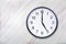 Wall clock show five o`clock on marble texture. Office clock show 5pm or 5am