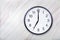 Wall clock show seven o`clock on marble texture. Office clock show 7pm or 7am