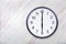 Wall clock show six o`clock on marble texture. Office clock show 6pm or 6am