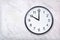 Wall clock show ten o`clock on white marble texture. Office clock show 10pm or 10am
