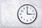 Wall clock show three o`clock on white marble texture. Office clock show 3pm or 3am