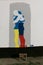 wall with colored paint drawing of man and woman silhouettes hugging colored with Ukrainian and Russian flags