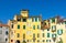 Wall of colorful buildings with shutter windows on Piazza dell Anfiteatro square in circus yard of medieval town Lucca