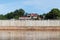 Wall of concrete pillars blocking the river.