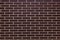 Wall of dark brown ceramic bricks, ceramic tiles.