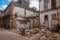 The wall of the destroyed house and a lot of garbage on the ground on the street. Havana. Cuba