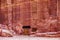 Wall with the door, the entrance to the temple, carved into the red sandstone rock in the canyon.