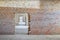 Wall and doorway inside the building under construction. Perspective view of corridor and brick walls for background