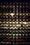 Wall of empty wine bottles. Empty wine bottles stacked-up on one another in pattern lit by the light coming from behind