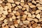 Wall firewood , Background of dry chopped firewood logs in a pile. Stack of logs felled and left to dry.