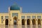 Wall full of arches and a beautiful blue dome.